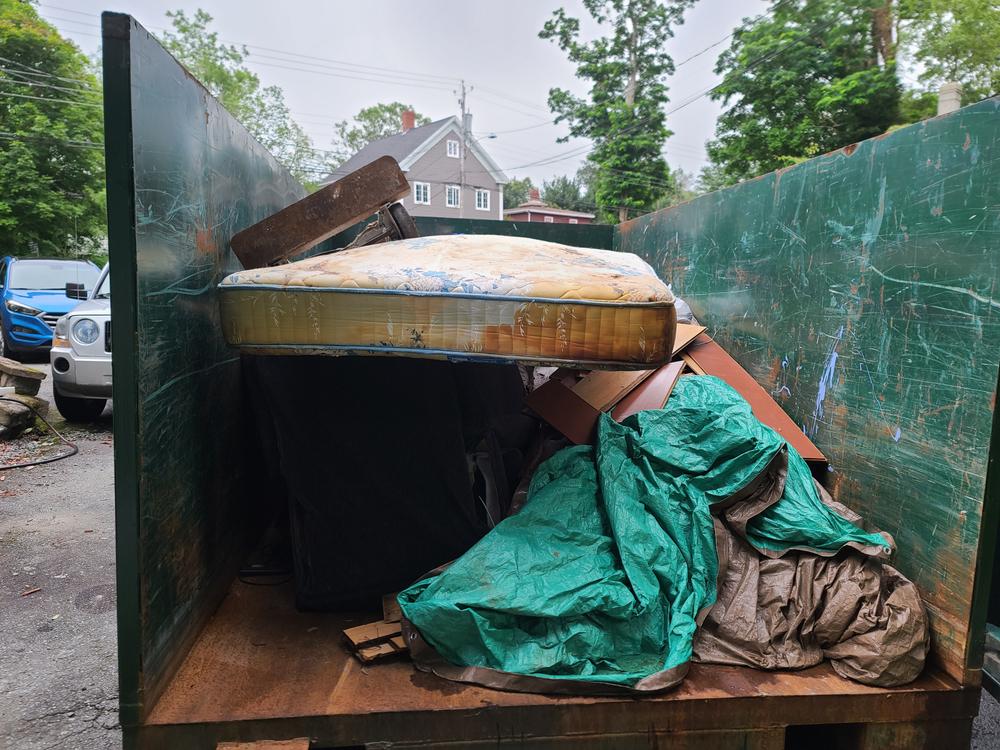 The,Contents,Of,A,Half,Filled,Up,Dumpster.,Tarp,,Boards