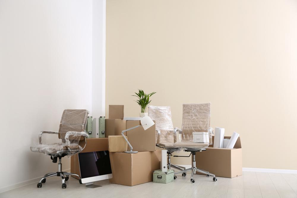 Moving,Boxes,And,Furniture,In,New,Office.,Space,For,Text