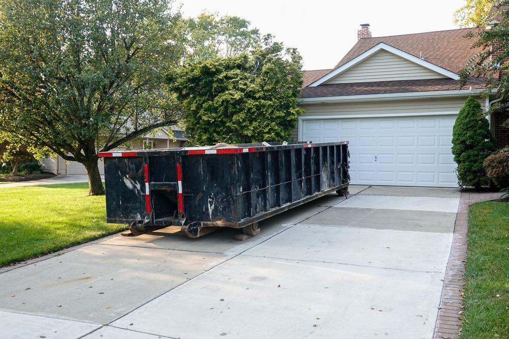 Long,Blue,Dumpster,Full,Of,Wood,And,Other,Debris,In