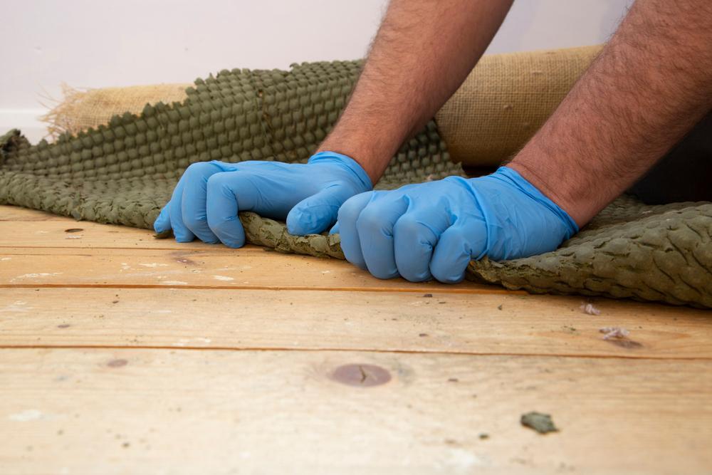 Man,Removing,Carpet,Underlay,From,A,Wooden,Floor.home,Improvement,Project