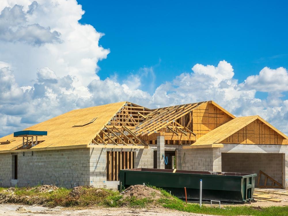 Single Family,House,Under,Construction,,With,A,Long,Dumpster,Near,Entrance